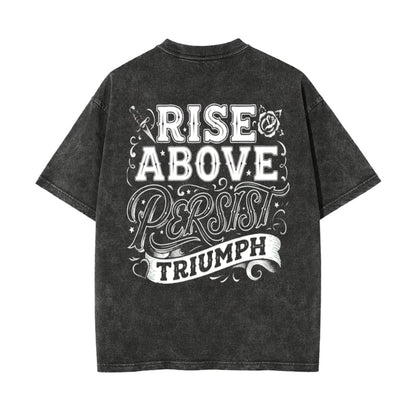 A dark gray acid-wash t-shirt shown from the back, featuring a large white graphic print that reads 'RISE ABOVE PERSIST TRIUMPH' with decorative lettering and small illustrations.