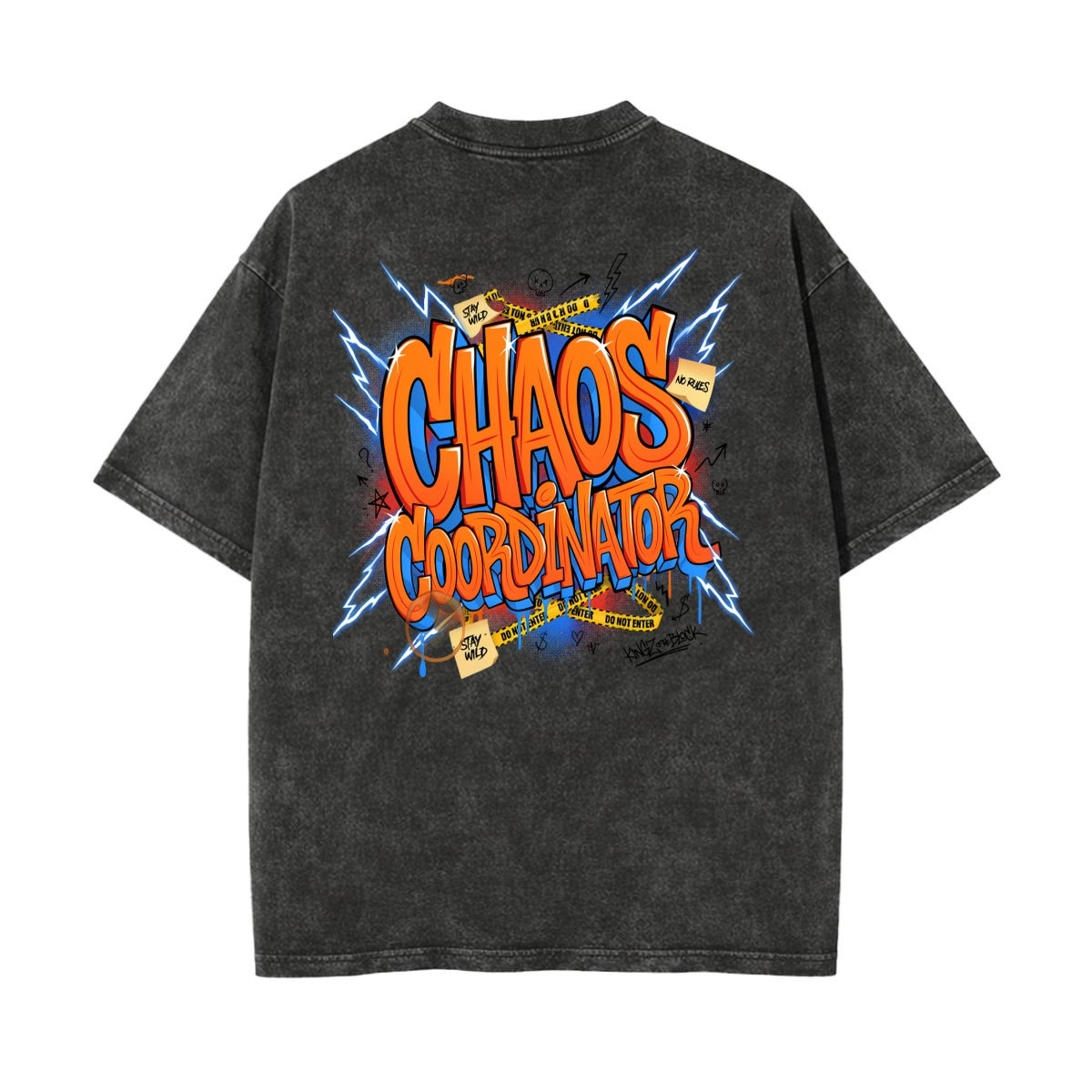 A dark gray acid-wash t-shirt shown from the back, featuring a large colorful graphic print with the text 'CHAOS COORDINATOR' in orange and yellow, surrounded by blue lightning bolts and comic-style elements.