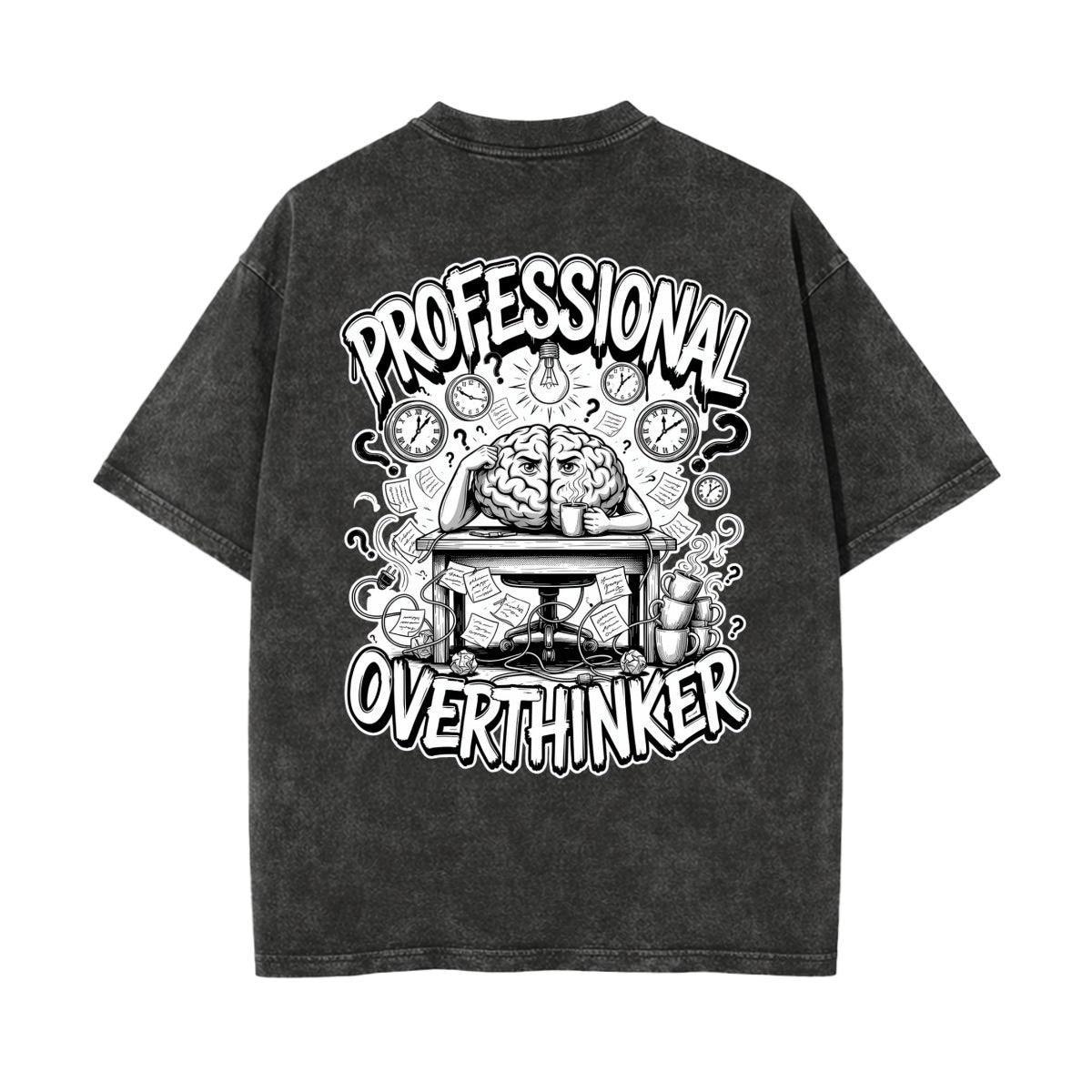 A dark gray acid-wash t-shirt shown from the back, featuring a large black and white graphic print with the words 'PROFESSIONAL OVERTHINKER' and an illustration of a brain working at a desk surrounded by clocks.