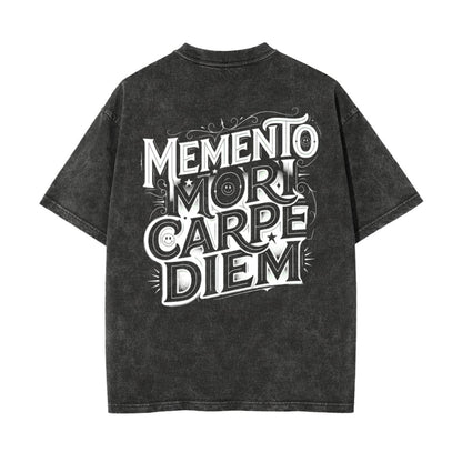A dark gray acid-wash t-shirt with a large white graphic text print reading 'MEMENTO MORI CARPE DIEM' on the back, shown against a plain white background.