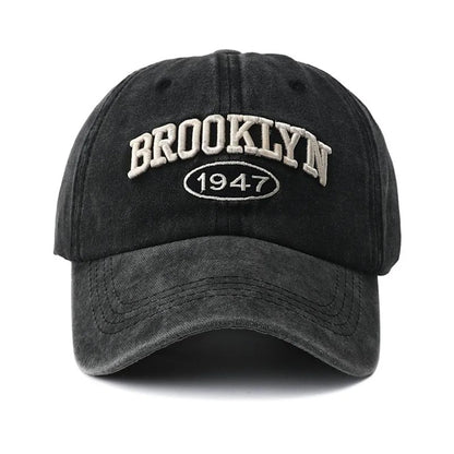 Black embroidery cap with 'Brooklyn 1947' text on a white background