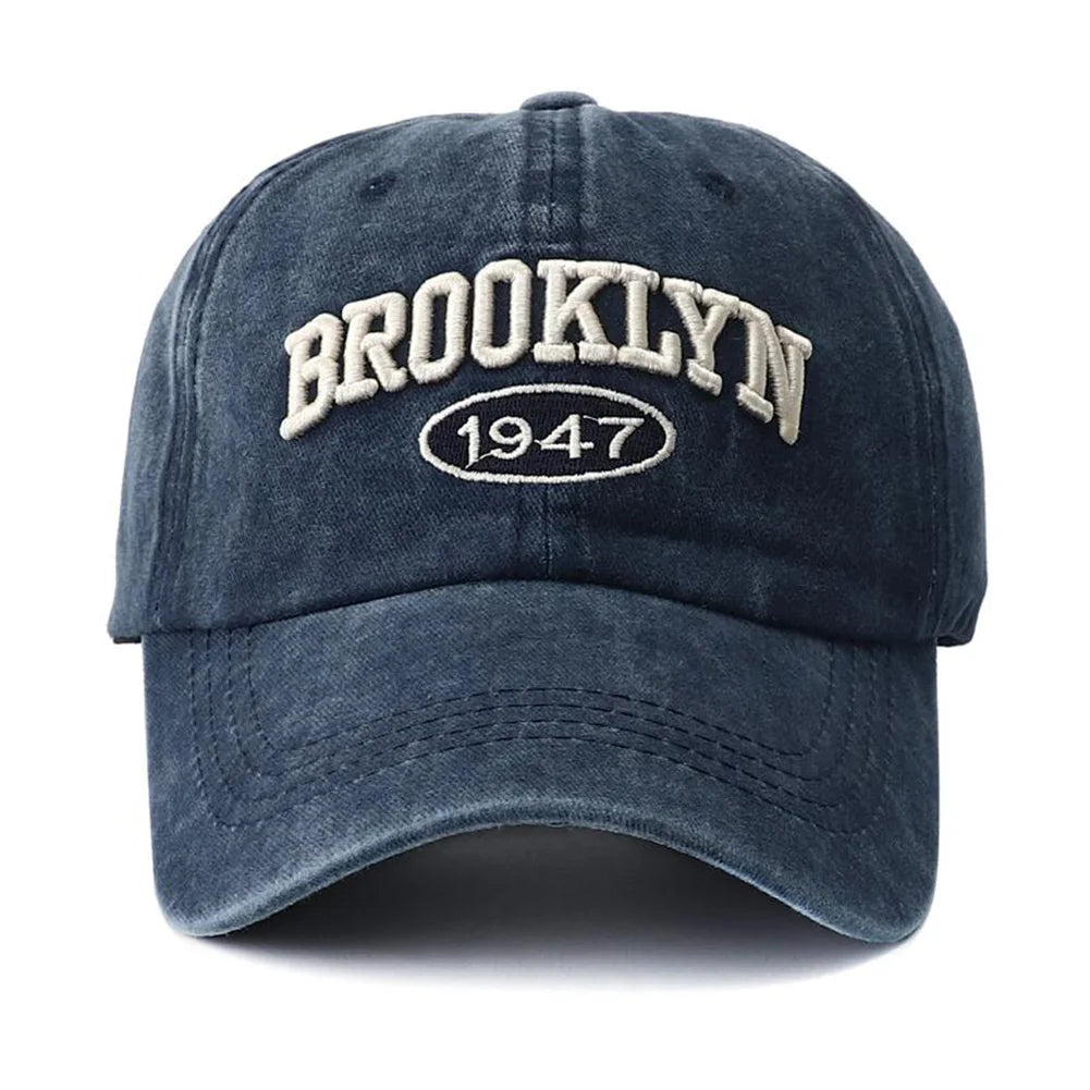 Blue embroidery cap with 'Brooklyn 1947' text on a white background
