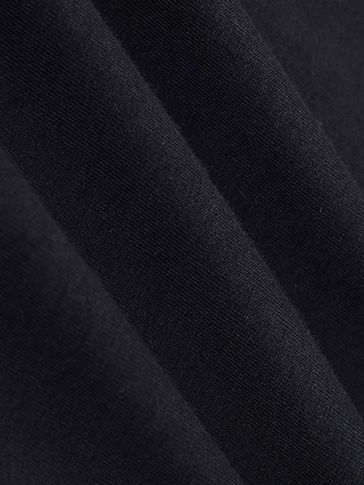 Close-up of black t shirt fabric with a textured pattern
