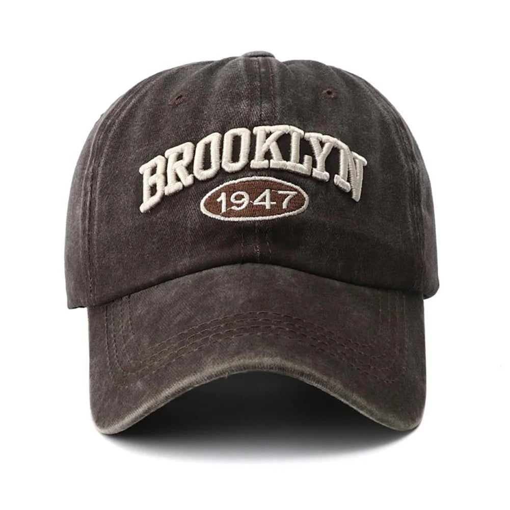 Dark brown cap with 'Brooklyn 1947' text on a white background