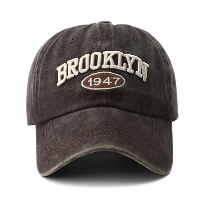 Dark brown cap with 'Brooklyn 1947' text on a white background