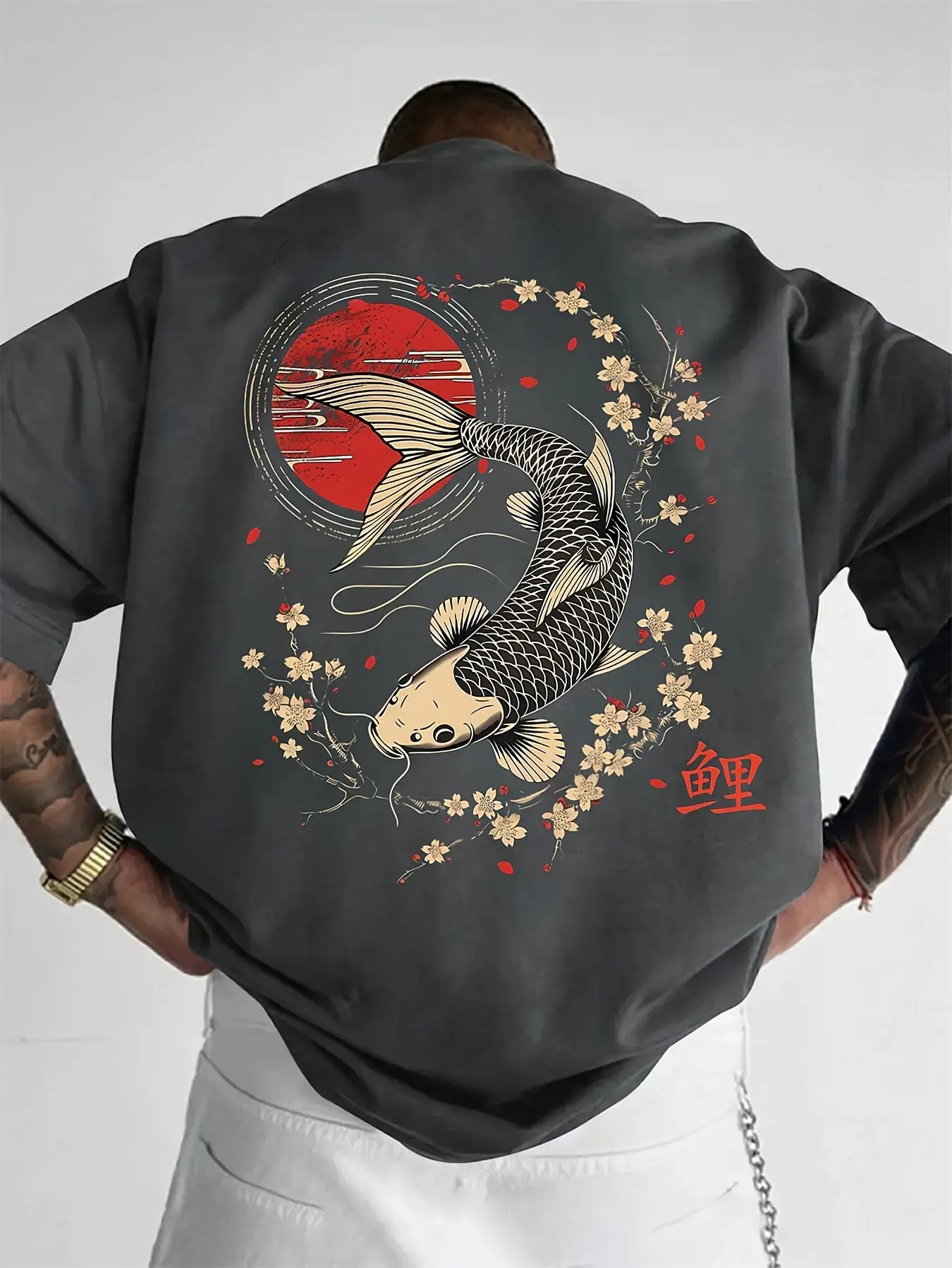 Person wearing a Dark Gray koi fish oversized t shirt with a koi fish and cherry blossom design on the back.