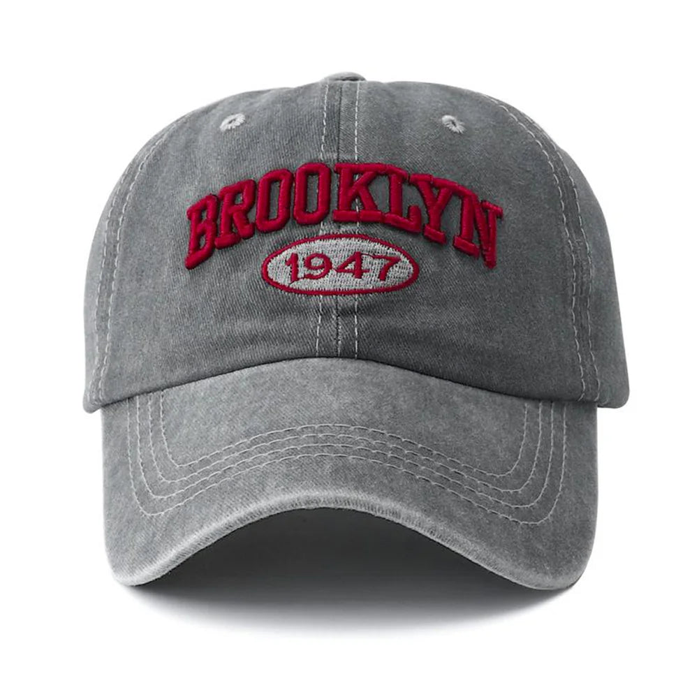 Gray brooklyn cap with 'Brooklyn 1947' text in red on a white background