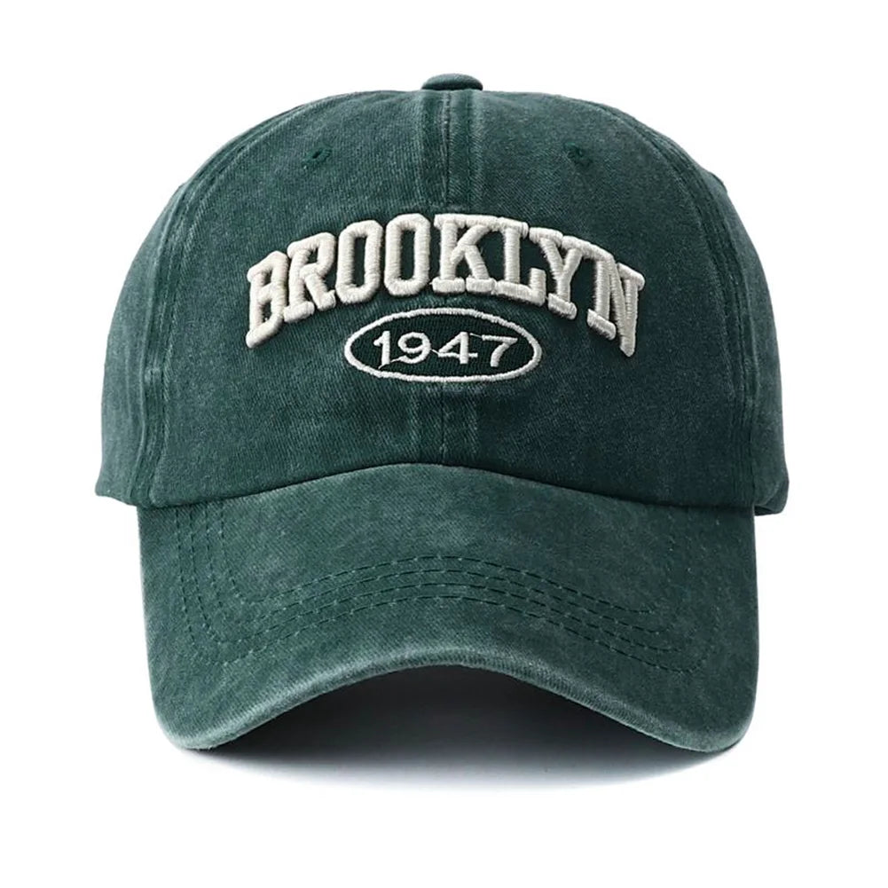 Green cap with 'Brooklyn 1947' text on a white background