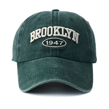 Green cap with 'Brooklyn 1947' text on a white background