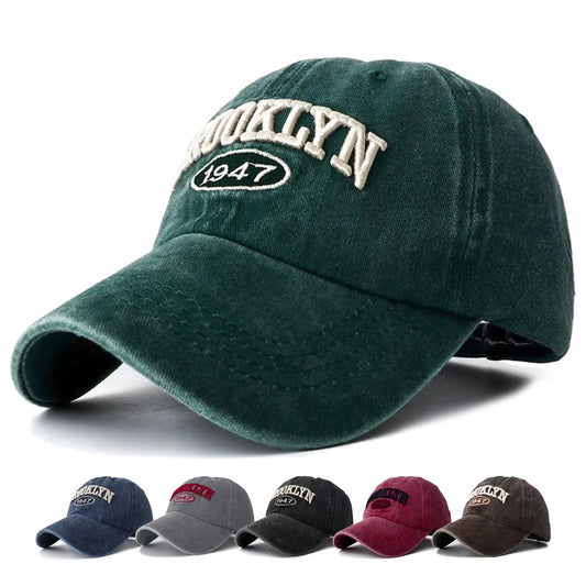 Green embroidery cap with 'Brooklyn 1947' text on a white background, with additional caps in different colors below.