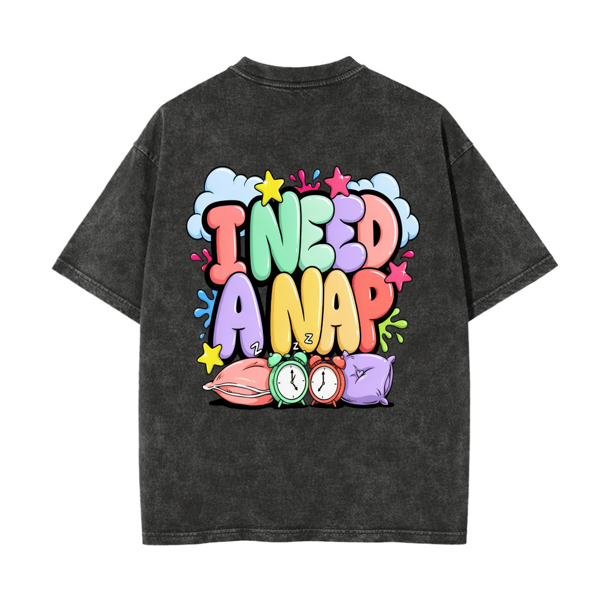 A dark gray  t-shirt shown from the back, featuring a colorful retro graphic that reads 'I NEED A NAP' in bubble letters with cartoon alarm clocks and clouds.