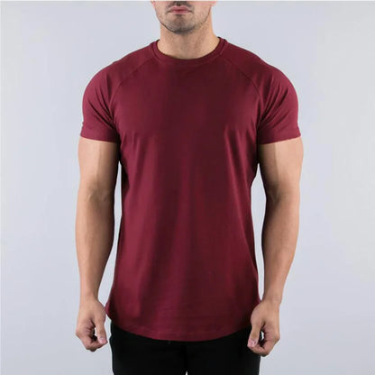 Maroon t-shirt worn by a person on a plain background