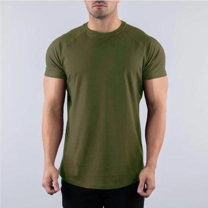 Person wearing an army green plain t shirt for gym and sports against a plain background