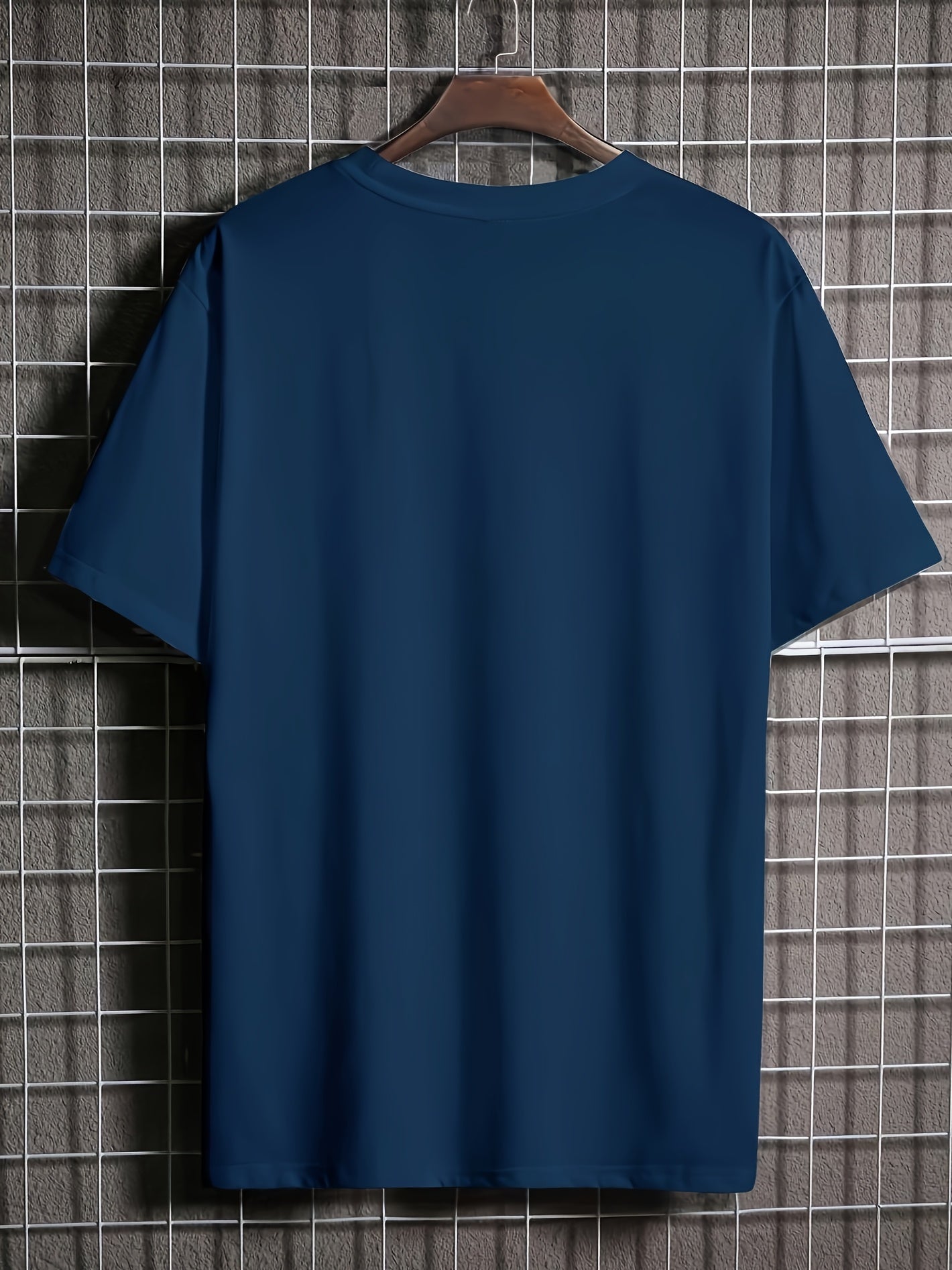 back view, Blue moon tee on a hanger against a tiled wall background