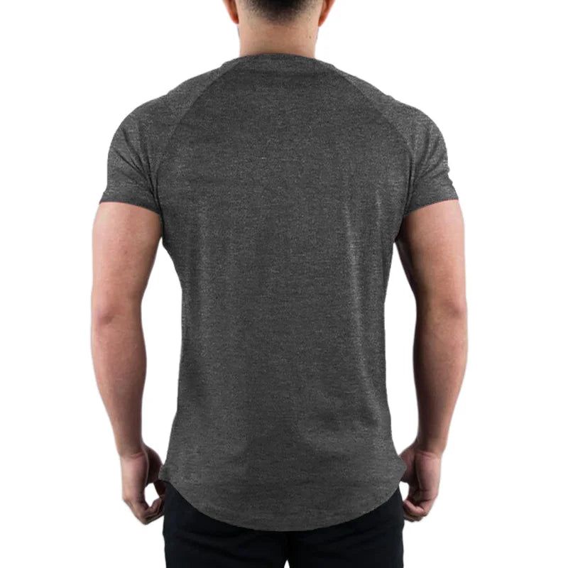 Person wearing and showing  back of a plain gray t-shirt on a white background
