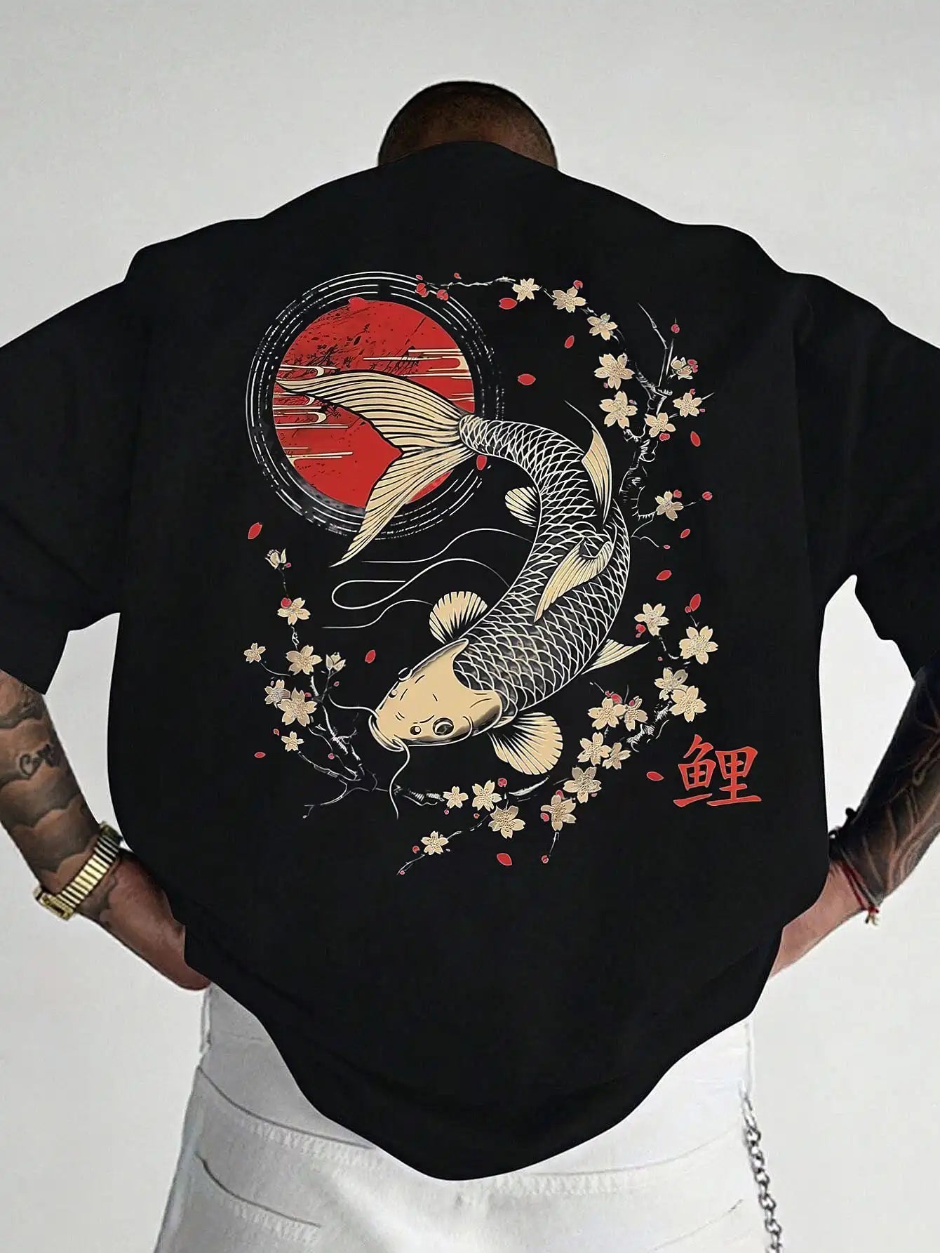 Person wearing a black koi fish oversized t shirt with a koi fish design on the back