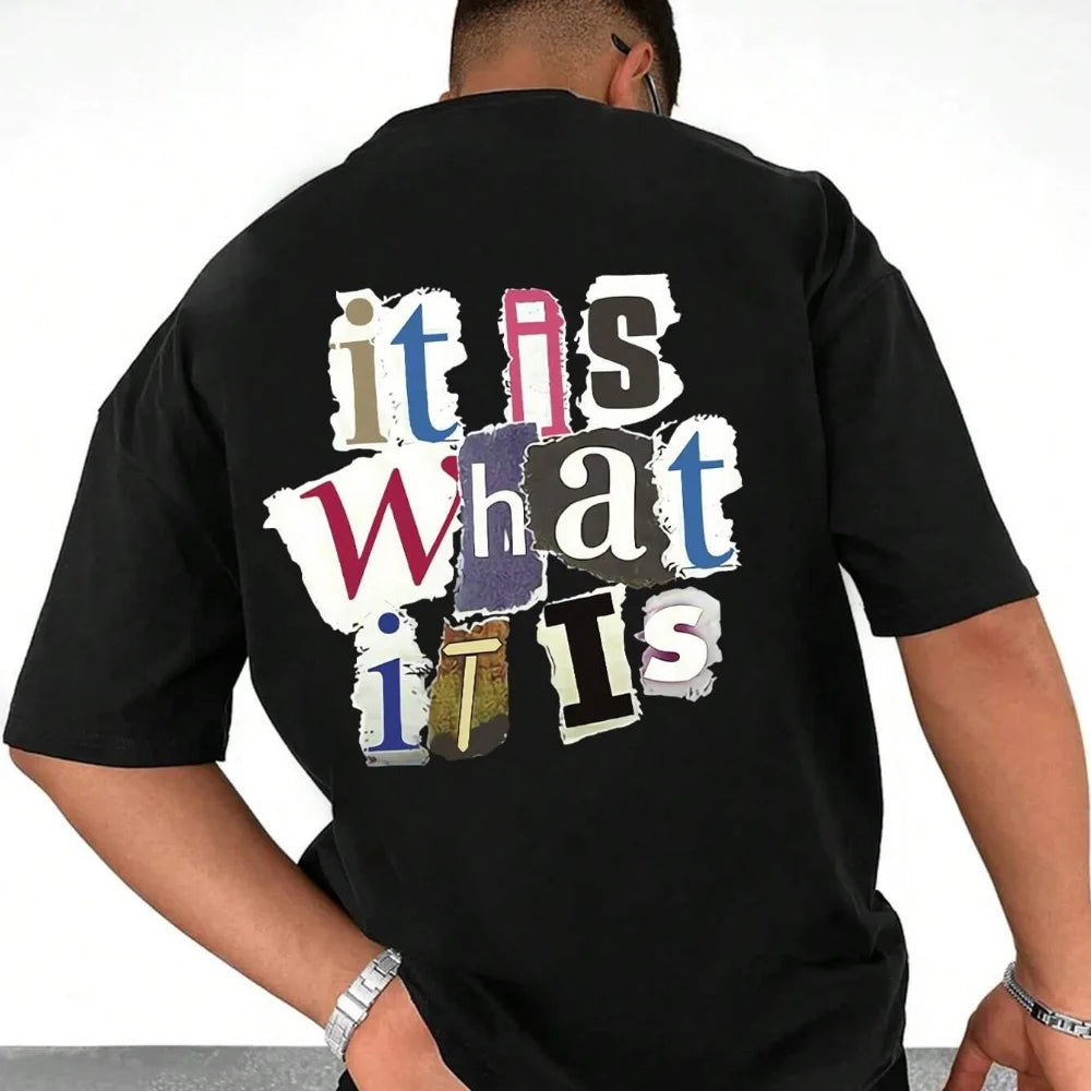 Person wearing a black slogan tee 2000s with colorful text design on the back.