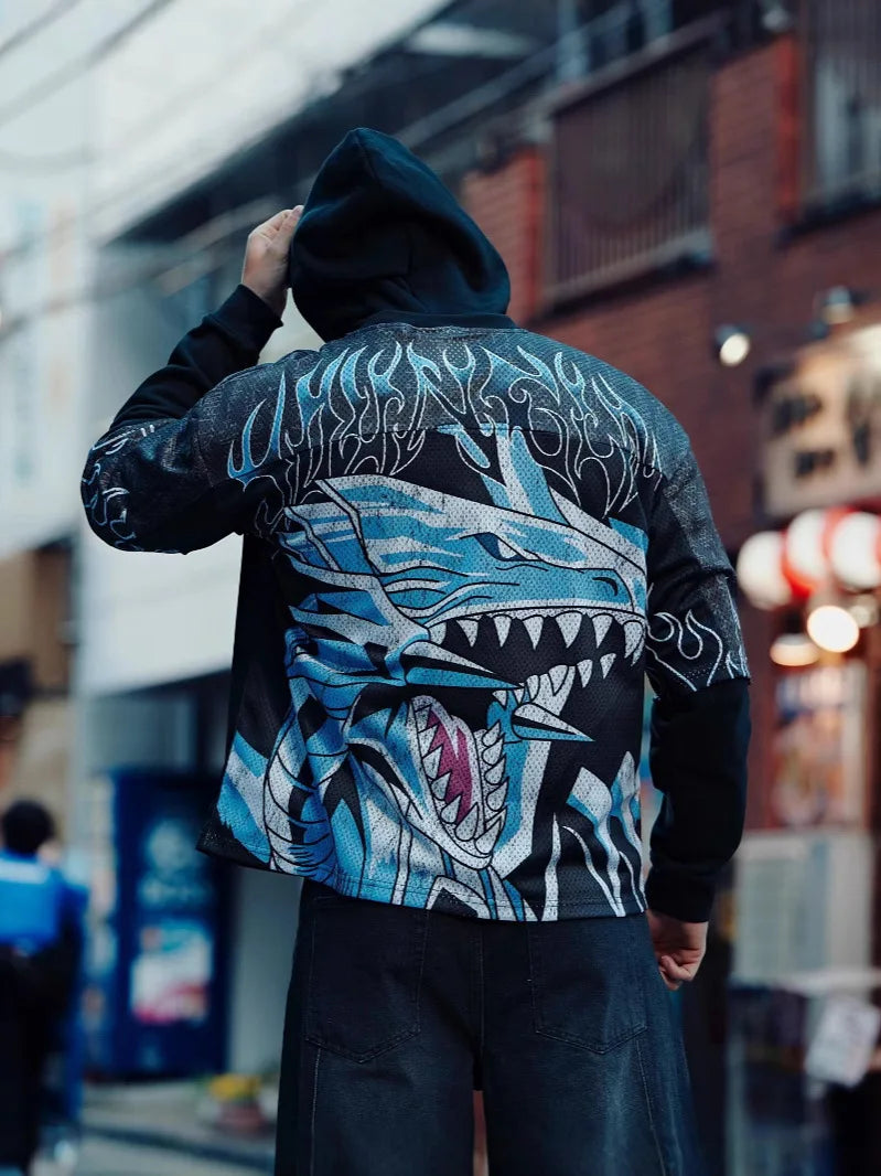 Person wearing an oversized anime graphic tee with a blue and black dragon design on the back, standing in an urban setting.
