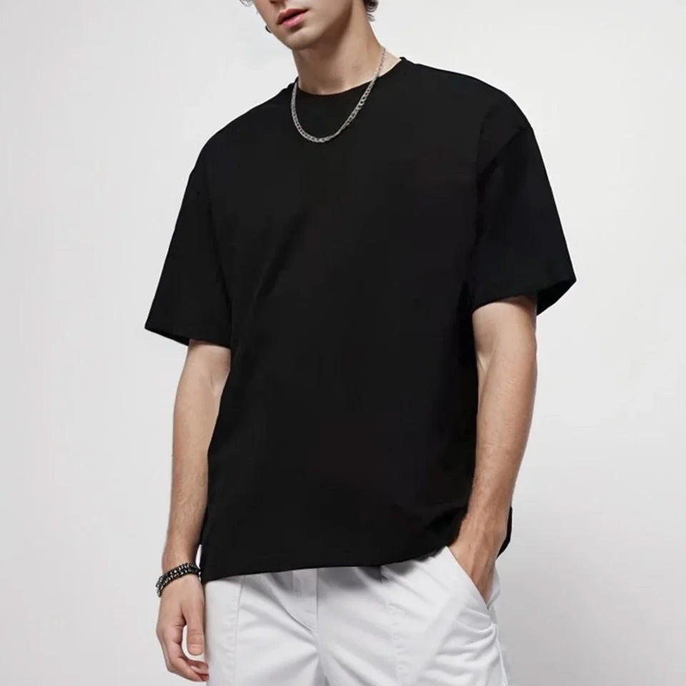 Person featuring a ultra weight  plain oversized black  t shirt