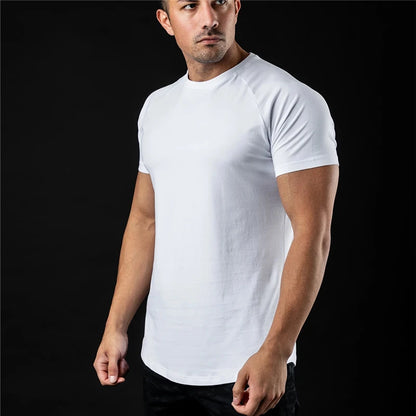 Man wearing a round neck plain white t shirt against a black background