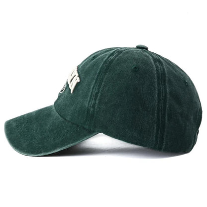 side view of Green Brooklyn cap on a white background